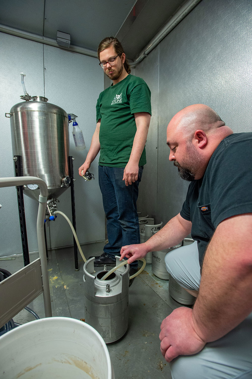 SIU Fermentation Science Student puts beer into a keg