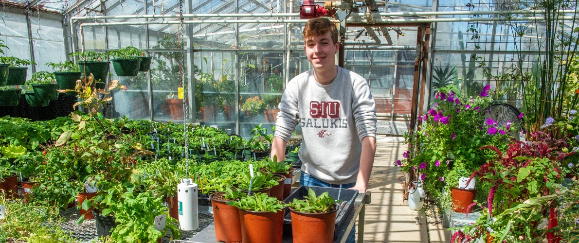 SIU student with greenhouse cart