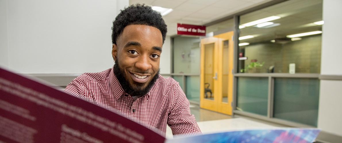 SIU Management student looks at the flyer