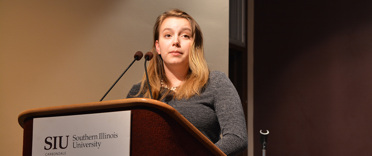 SIU Communication Studies student giving presentation at podium