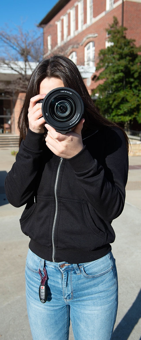 SIU digital media student with camera
