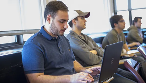 SIU Computer Science Student taking notes in class