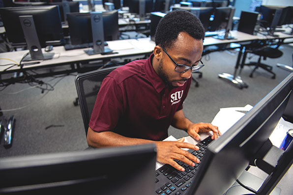 SIU Cybersecurity Student Working on Computer