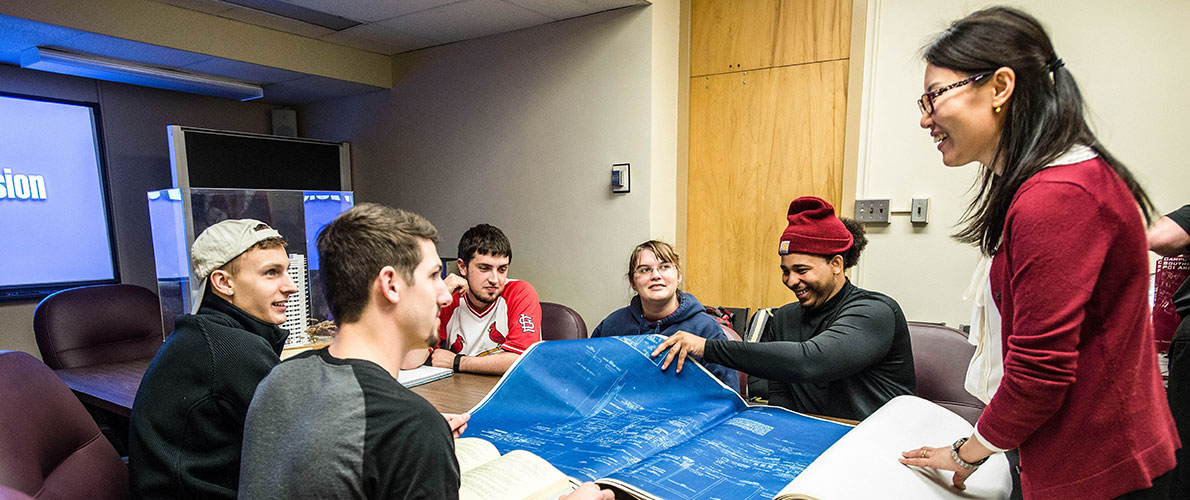 Students look over a blueprint