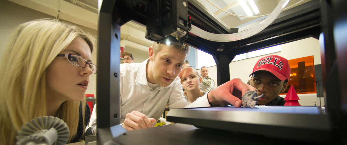 Professor and students with 3D printer