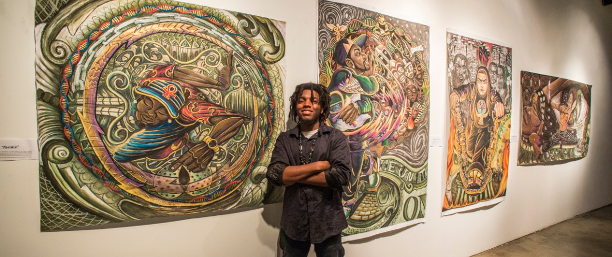 SIU student showing off paintings at exhibit