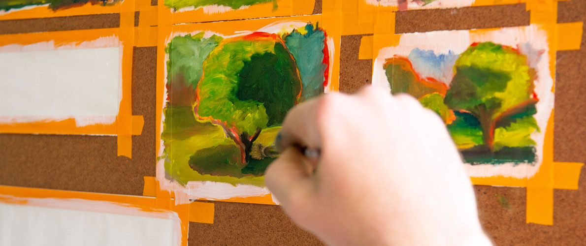 SIU Student Painting Trees on the quad