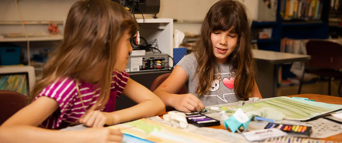 Two young girls working on art on SIU Campus