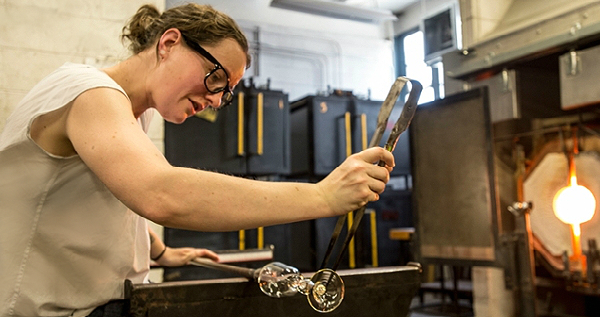 Student shaping glass