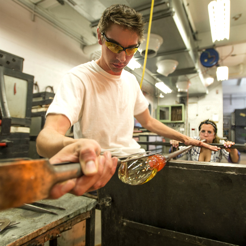 students blowing glass