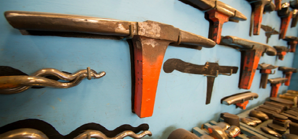 Metalsmithing equipment hanging on wall