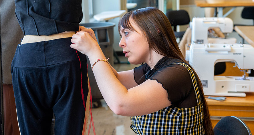 fashion student working on mannequin.jpg