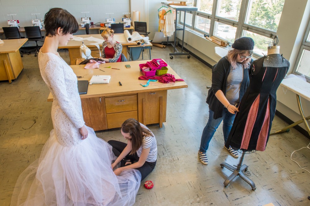 SIU Fashion students fitting clothes to their models