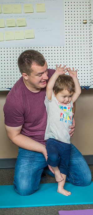 Child and Family Services Students do Yoga with little boy