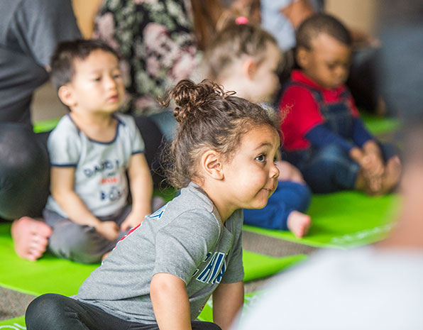 Little Girl does yoga with SIU Child and Family Services Students