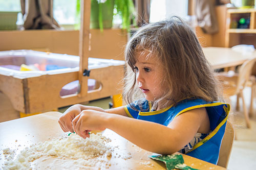 SIU Grow Your Own Teachers Program Little Girl playing with sand