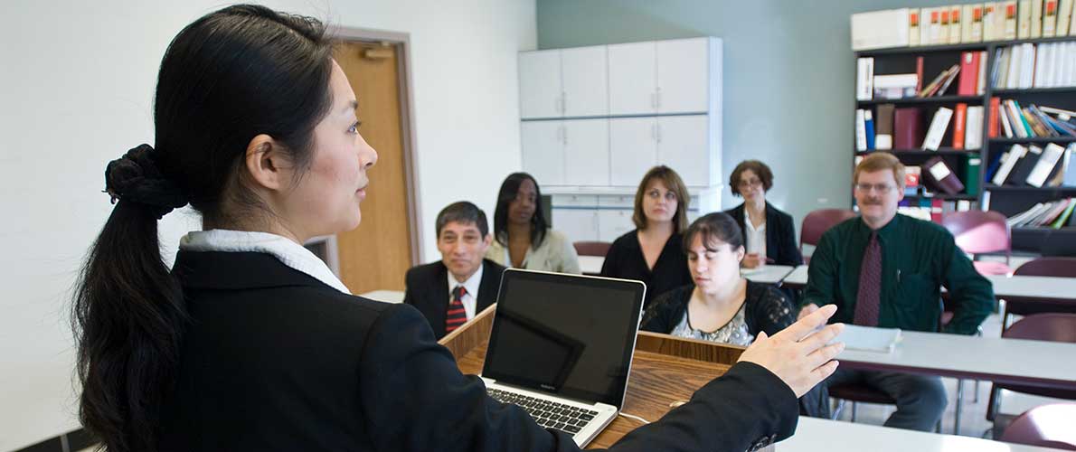  Organizational Learning, innovation, and development professor speaks in front of a class