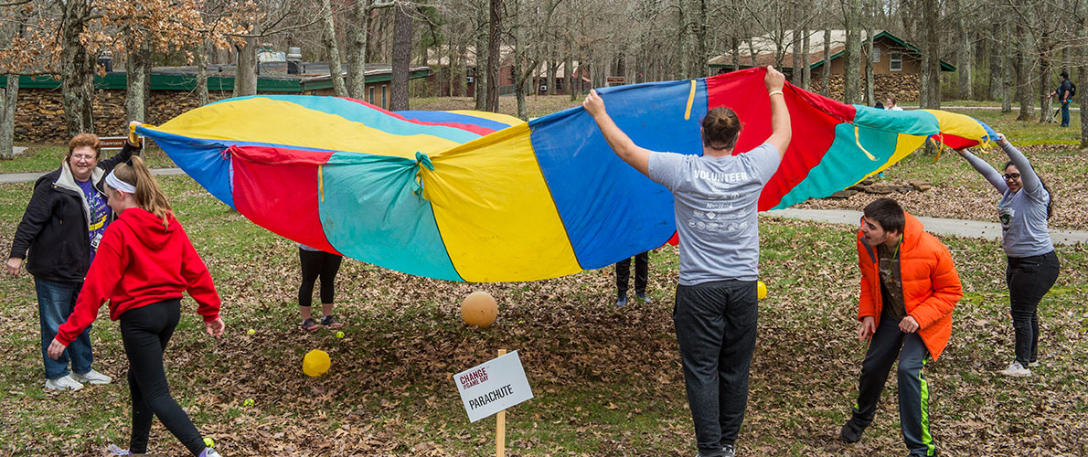 SIU Special Education Student playing with Children with a Parachute