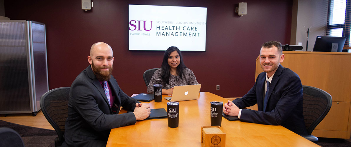 Health Care Management students (professionally dressed) in the Dean’s conference room.