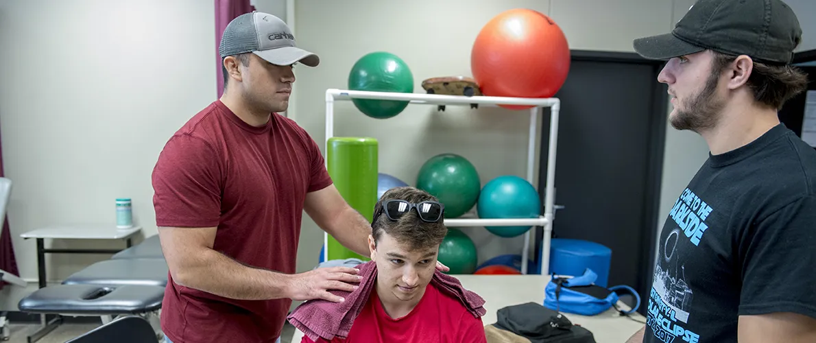 Group of Physical Therapist Assistant students practice on  fellow students