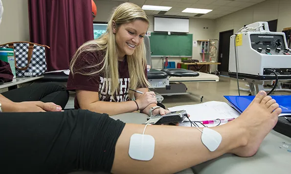 Physical Therapist Assistant student practice on  fellow student