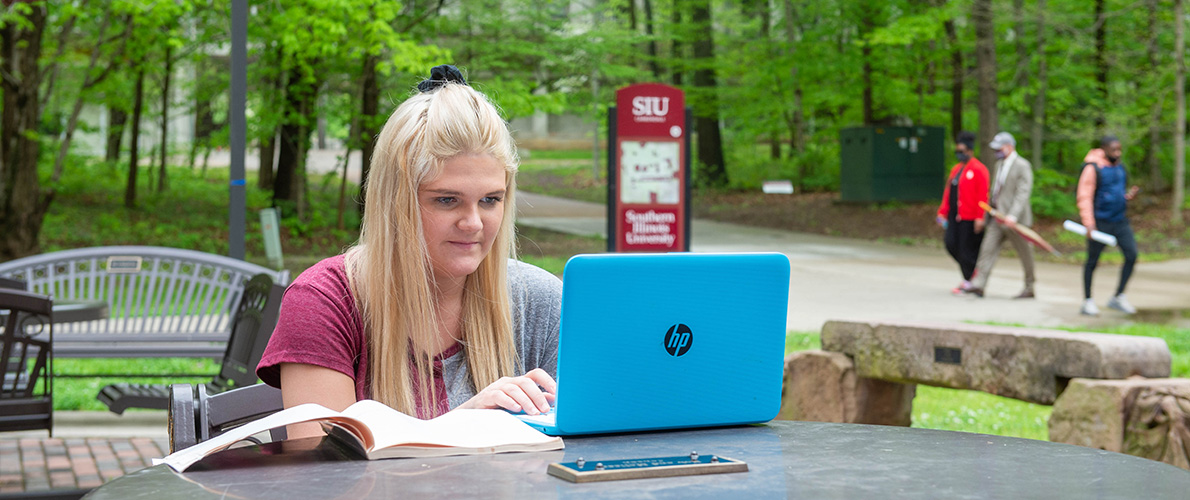 SIU undergraduat social work student studying outside