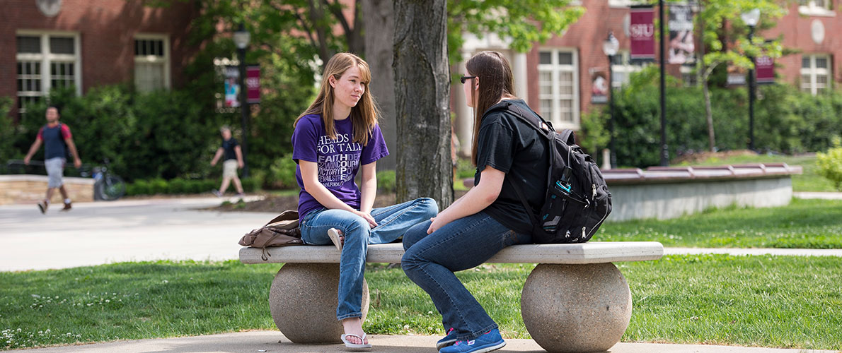 Group of SIU Students sitting on a Bench on Campus