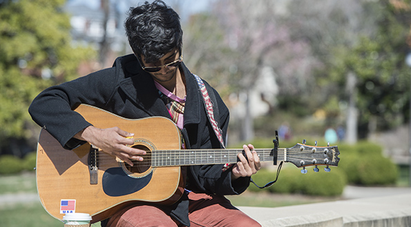 SIU Performance Guitar Student playing on campus
