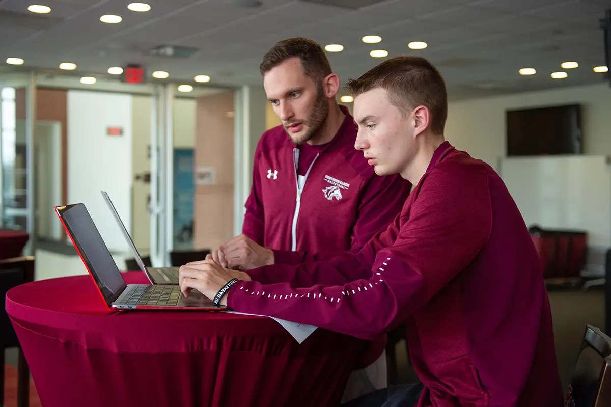SIU Students work on computer in athletic department.