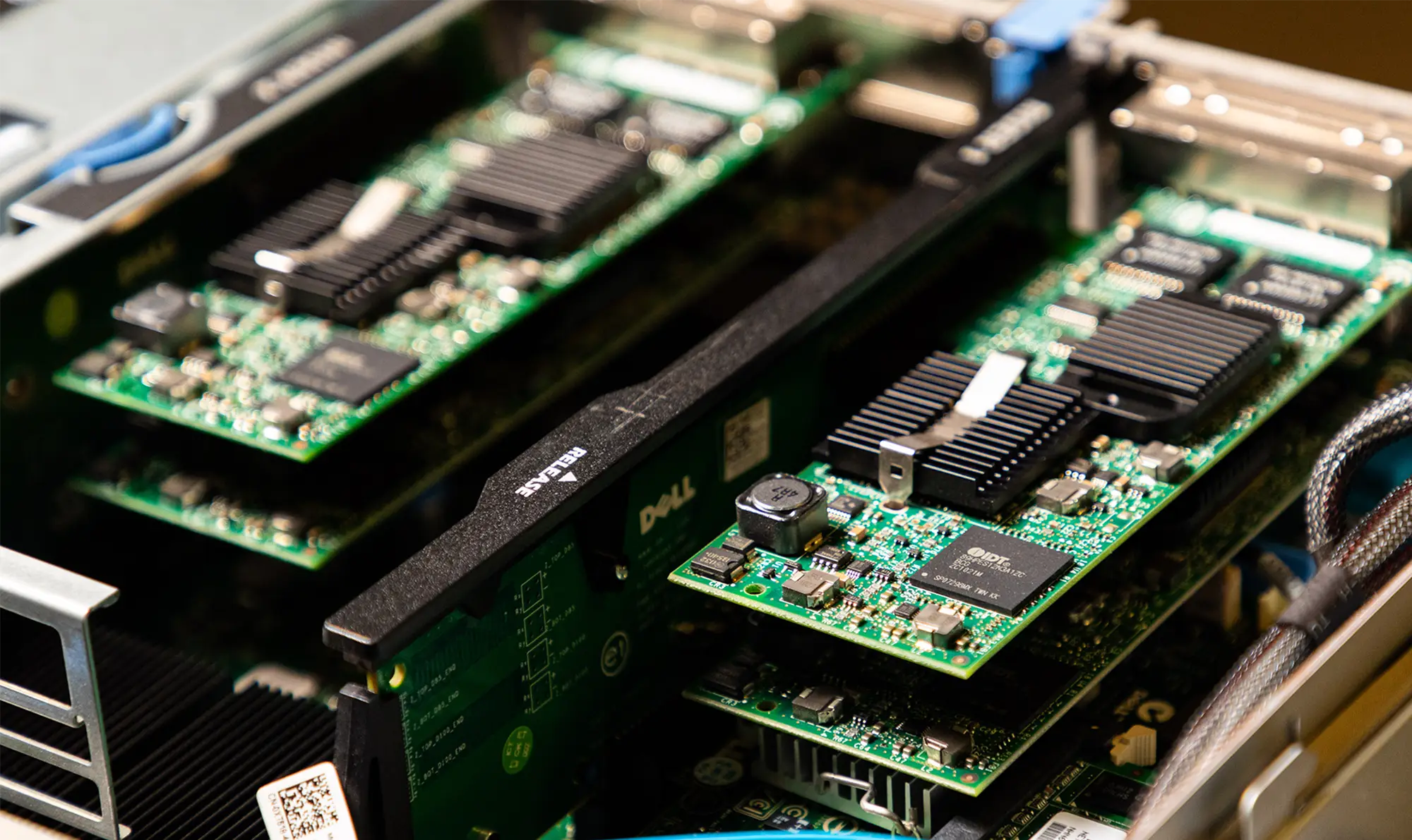 A close-up of Dell server hardware showing circuit boards, memory modules, and expansion cards inside an open rack-mounted server.