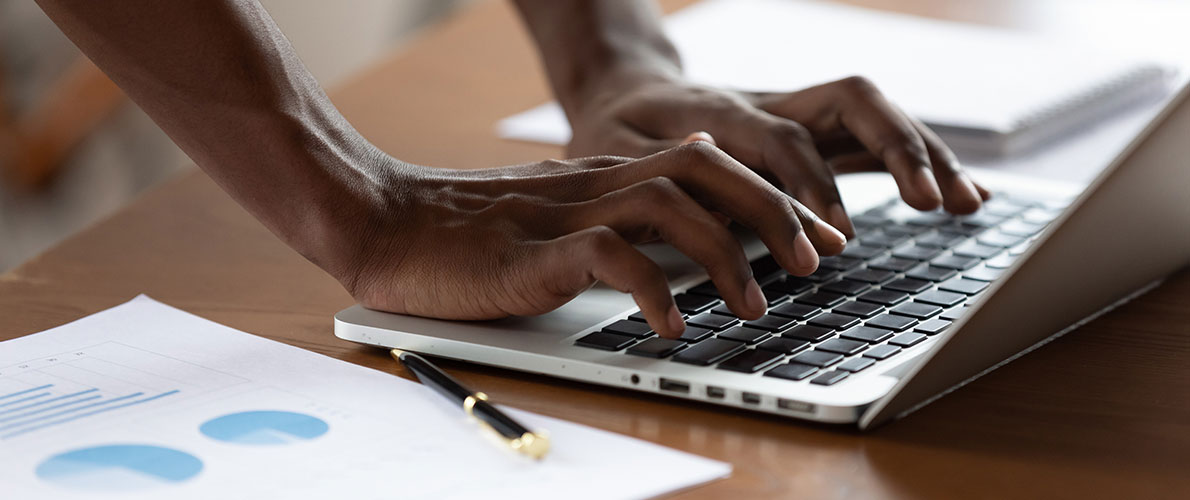 Close up of hands typing on keyboard