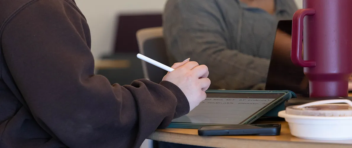 SIU student taking notes during class
